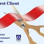 Setting Up a Hypnotherapy Practice: Your First Client A pair of gold scissors cutting a red ribbon to signify opening a therapy practice