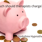 How Much Should Therapists Charge? A piggy bank and coins to illustrate how much should therapists charge