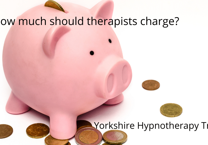 A piggy bank and coins to illustrate how much should therapists charge