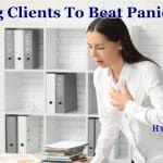 Help clients with panic attacks: a woman standing by a desk experiencing a panic attack