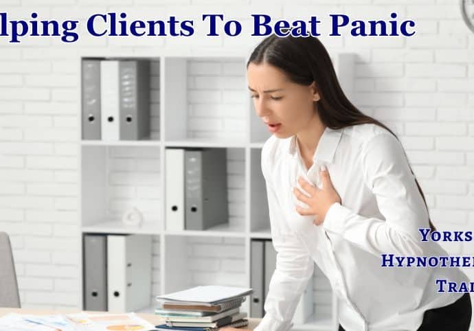 Help clients with panic attacks: a woman standing by a desk experiencing a panic attack