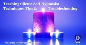 lit candles on a soothing blue background to signify calmness and self hypnosis